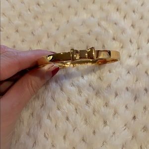 Kate spade gold bangle with a bow on it